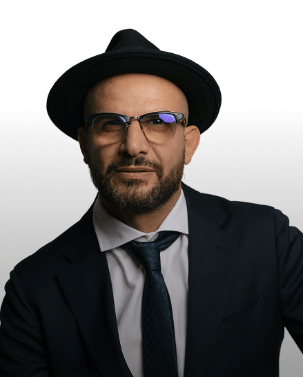 Eddine Belaid Owner and Master Stylist at TheBarber.ch Zurich wearing hat and suit