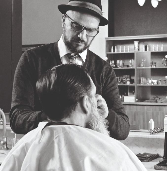 Master barber giving professional haircut to client in classic barber shop – TheBarber.ch Zurich
