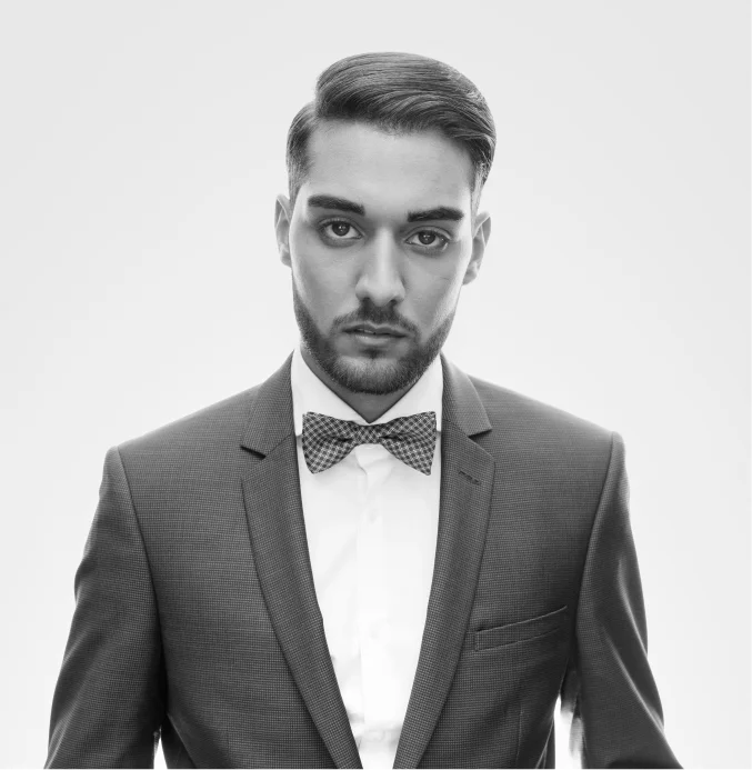 Elegant man in suit and bow tie with styled beard – TheBarber.ch beard color highlight and enhancement service Zurich